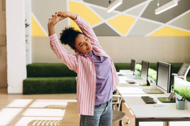 Office worker taking a short standing break near desk